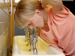 Girl drinking water from a fountain